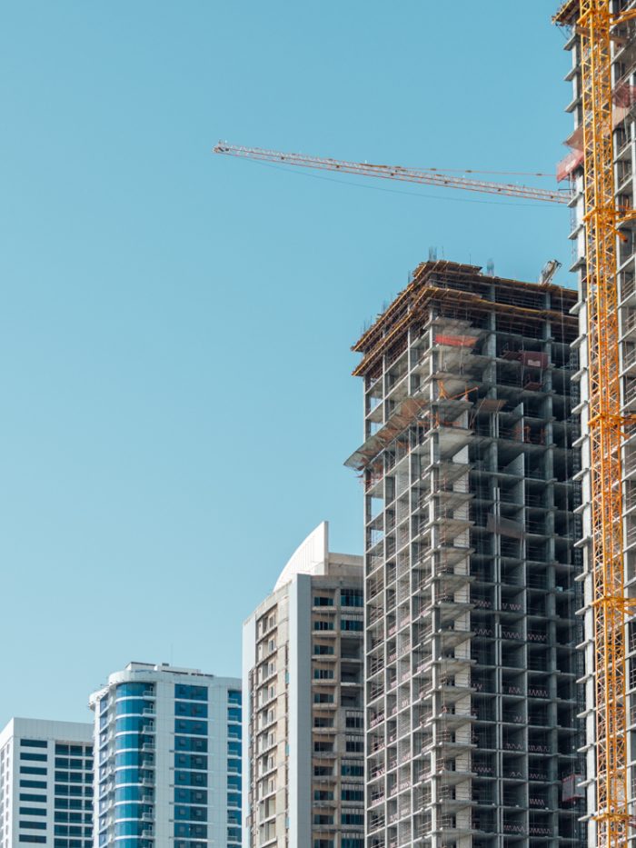 A photograph of a collection of high rise buildings at certain points of construction.