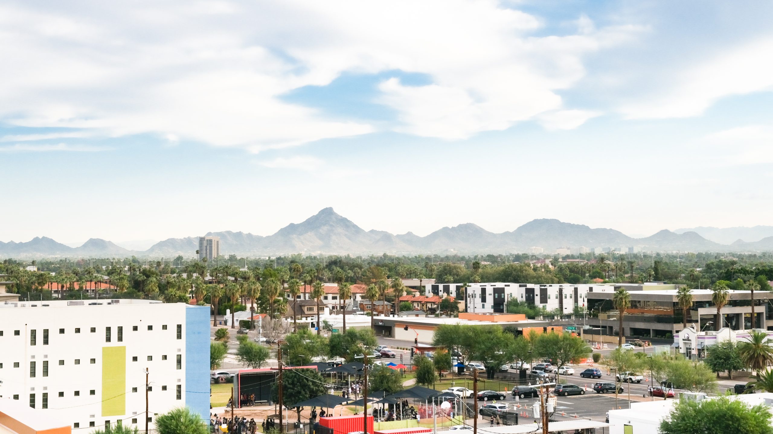 Photograph of the city of Phoenix with mountains in the background.