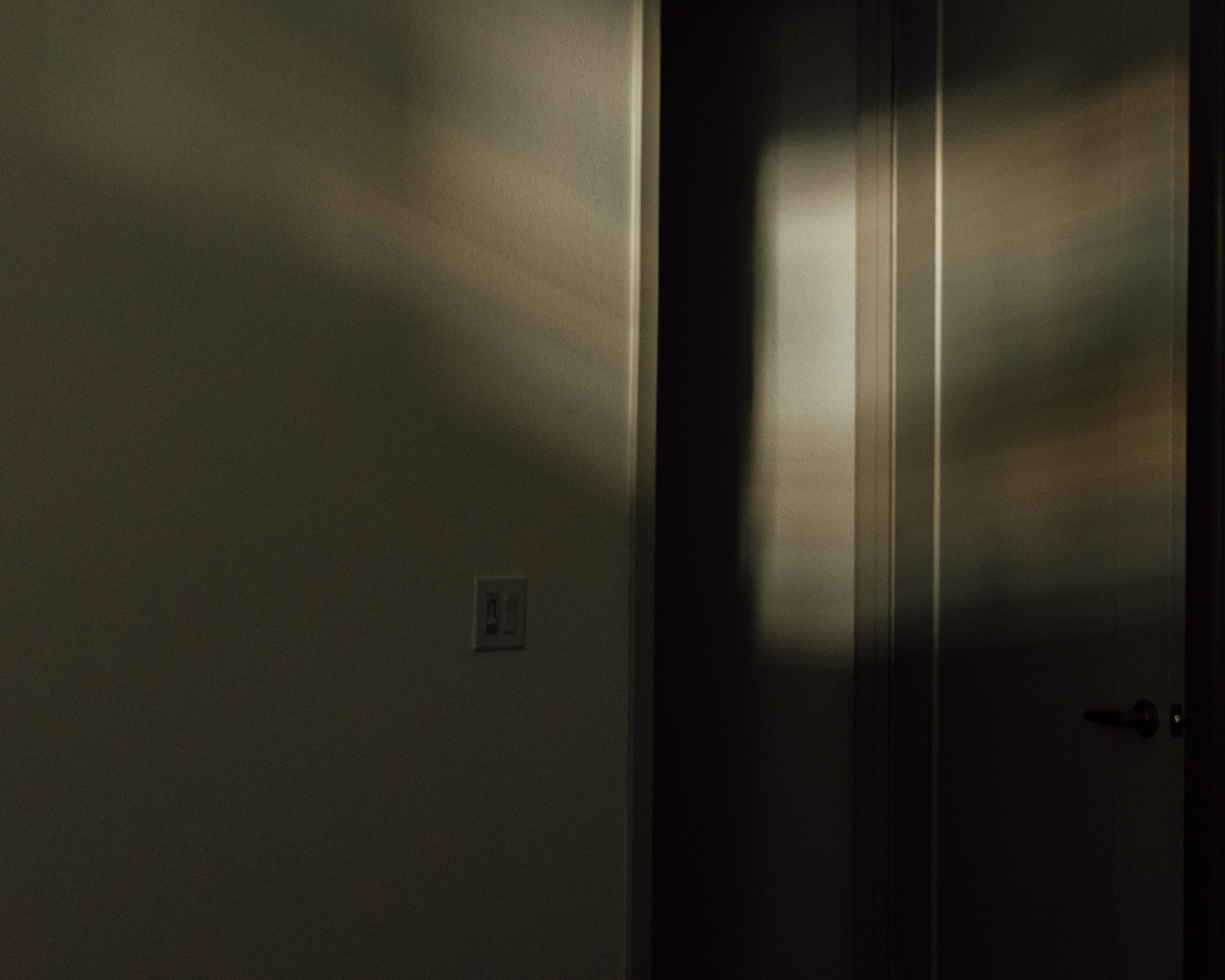 Photo of an open door into a hallway.