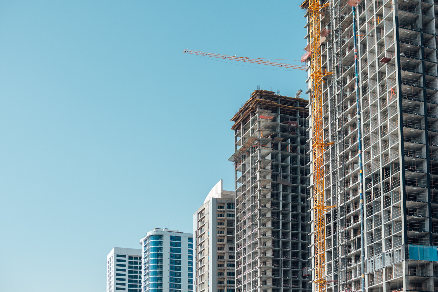 A photograph of a collection of high rise buildings at certain points of construction.