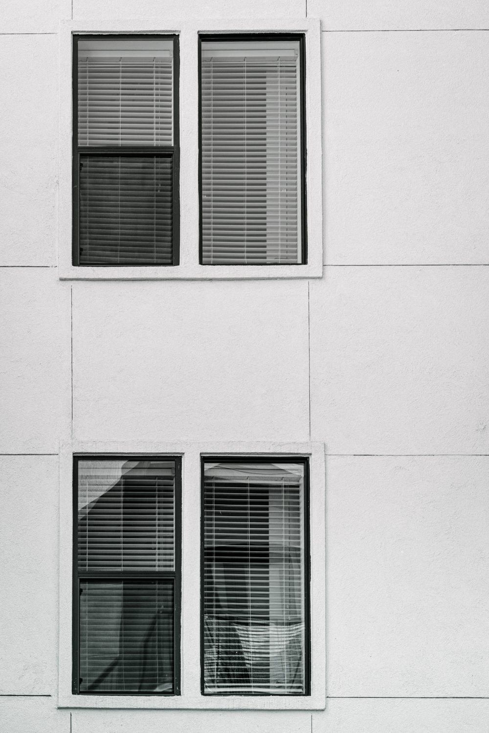 Black and white photo of windows on the side of a building.