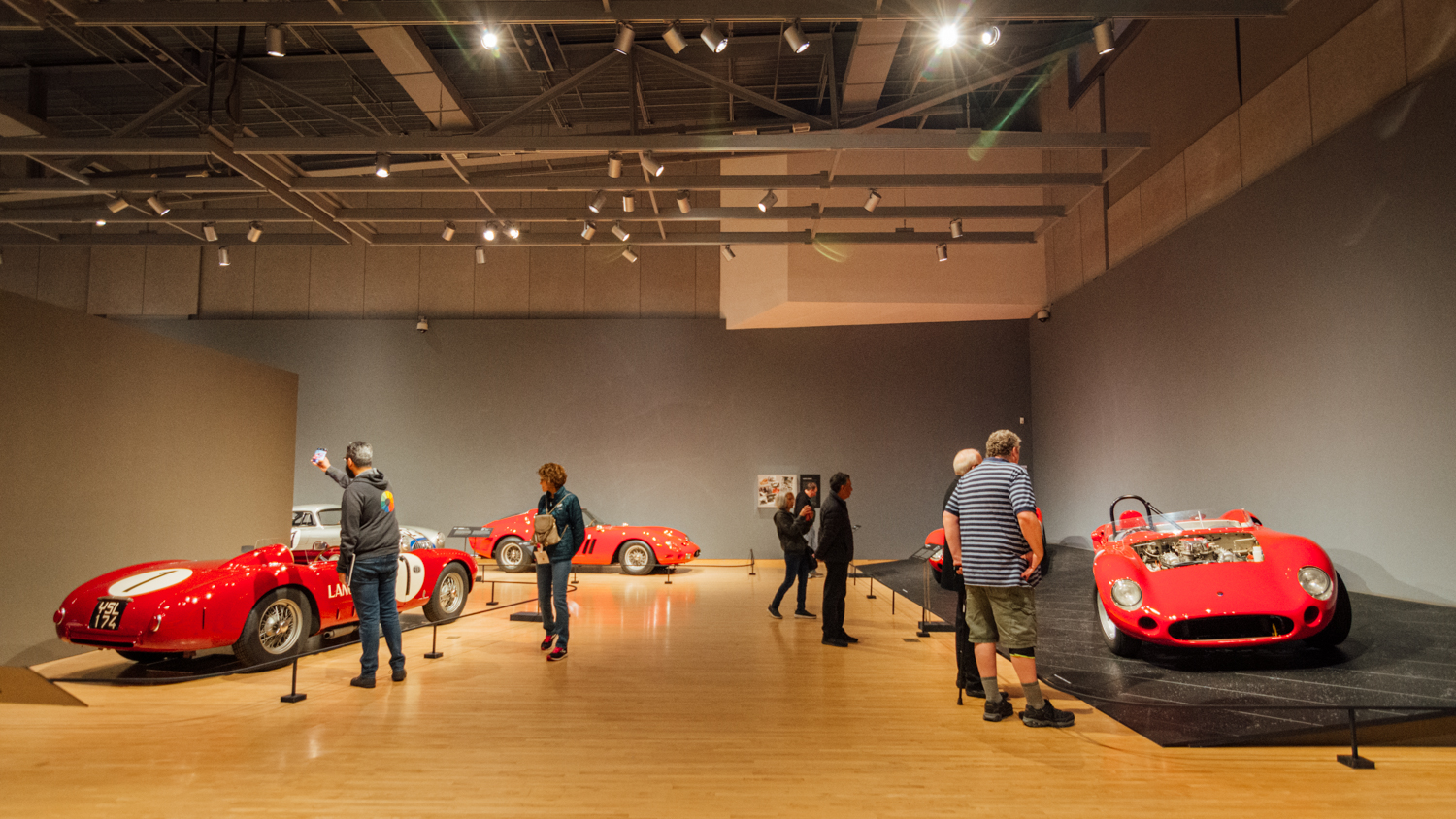Photo of the inside of a classic car exhibition in a museum.