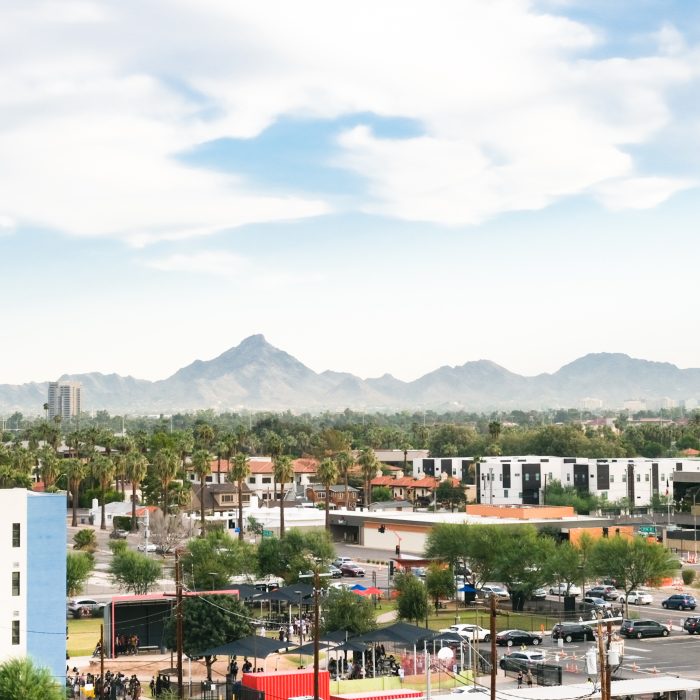 Photograph of the city of Phoenix with mountains in the background.